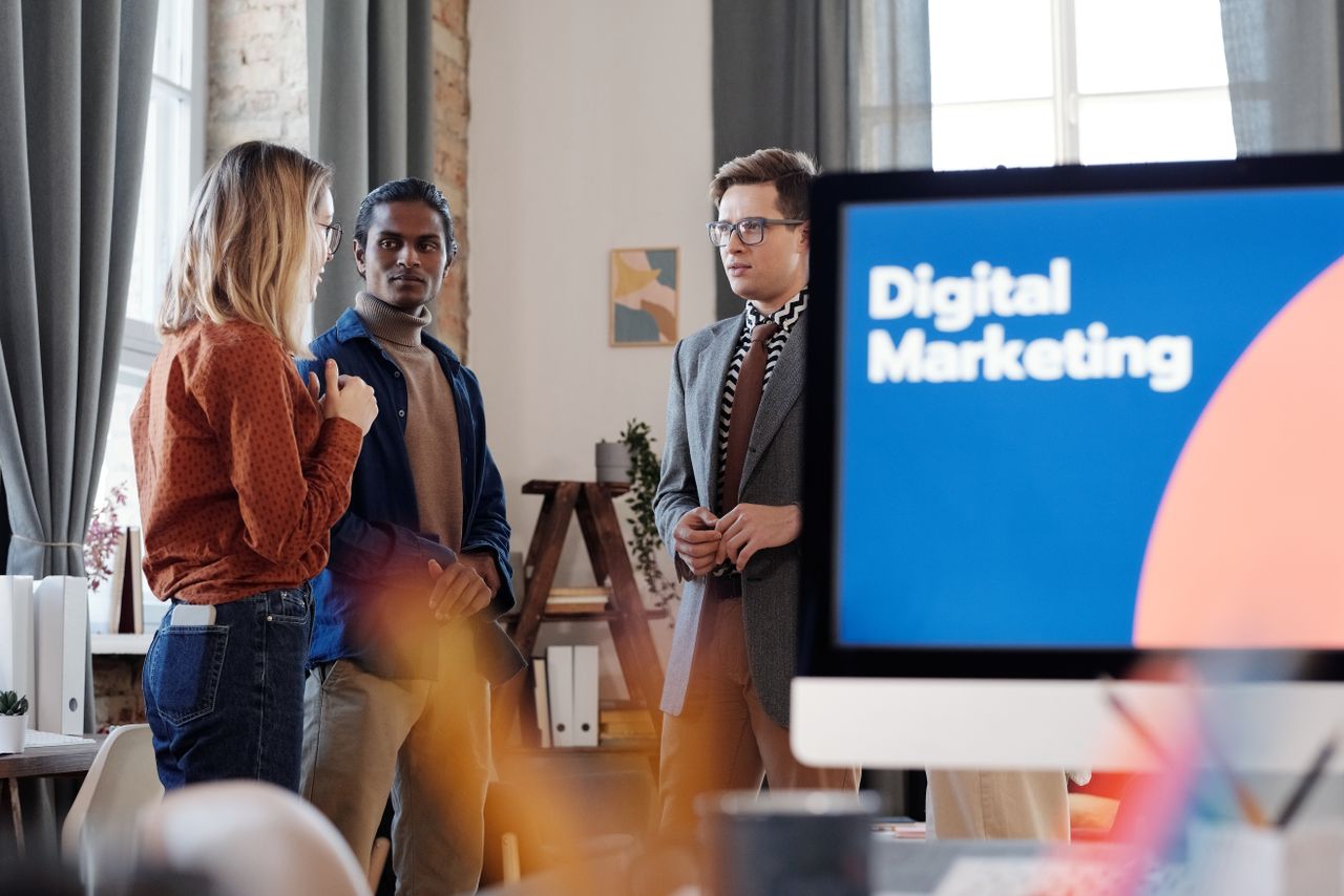 Mastering the First Impression: Your intriguing post title goes here Group of colleagues discussing digital marketing strategies in an office setting.