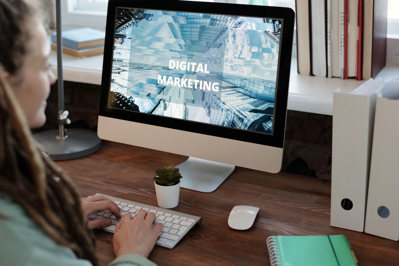 About Close-up of a woman working on a digital marketing project in a home office setting.